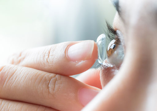 woman inserting contact lens